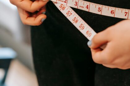 woman measuring her hips